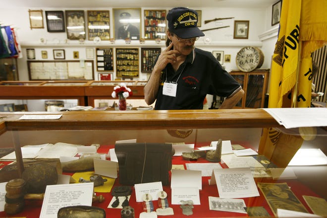 Roger DiVitto, in town for the VFW convention, looks over many of the artifacts in the Grand Army of the Republic museum Friday, June 26, 2009. The museum faces an uncertain fate; the state of Illinois no longer recognizes it as a charity and is forcing the museum to pay property taxes. Jason Johnson/The State Journal-Register