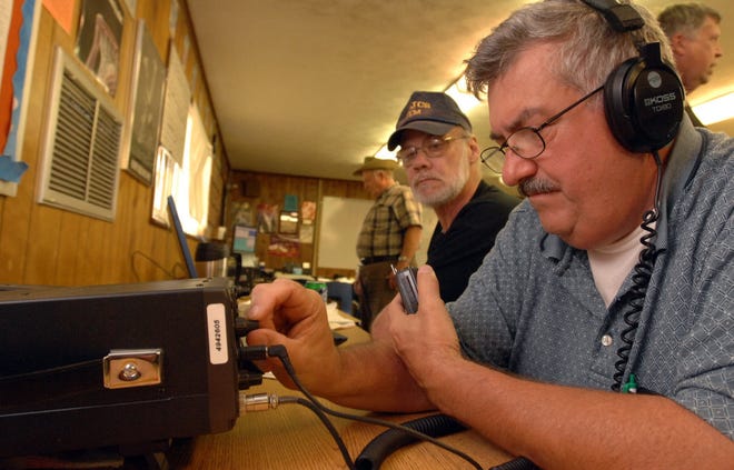 DON BURK/The Times-UnionJim Schroeder (left) and Adrian Gray work at making contact with other hams in the U.S. and Canada on Saturday at Lakeside Junior High School in Orange Park.