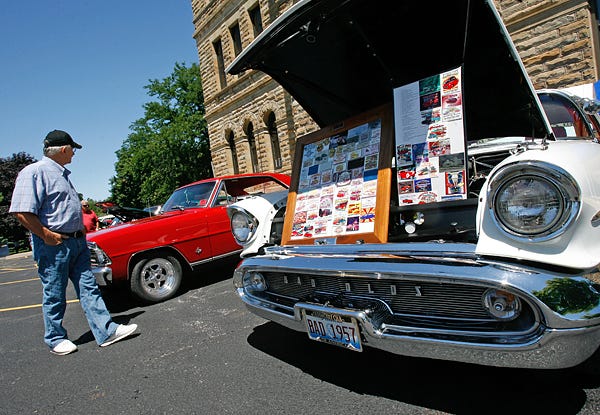 At right, a 1957 Oldsmobile 88 Holiday Coupe owned by Kiera Ricketts of Monmouth sits with decals and sticker displays in front of the Knox County Courthouse during the 24th Annual Showcase of Cars.