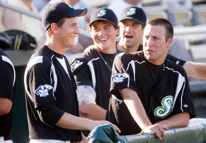 Purchase this photo at sj-r.com/reprints	
Ted Schurter/The State Journal-Register
Springfield Sliders outfielder T.J. Blanton, left, enjoys a moment in the dugout with teammates before Saturday’s game at Lanphier Park.
