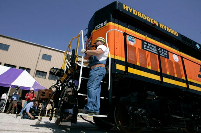 BNSF Railway groundsman Shawn Semple watches the tracks as he rides the Hydrogen Hybrid Engine, the he nation's first hydrogen-powered fuel cell locomotive, Monday at the BNSF shops in Topeka.