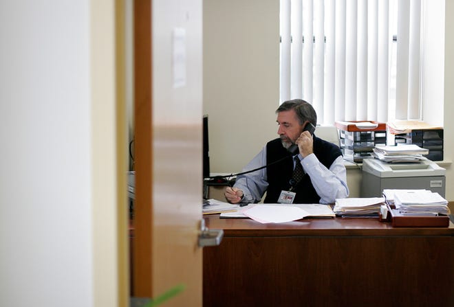 Dr. Stephen Hayes of Salem works at his office at the Lynn Community Health Center on Friday, June 12. He was recently recognized by the state for his pioneering work in mental health treatment.