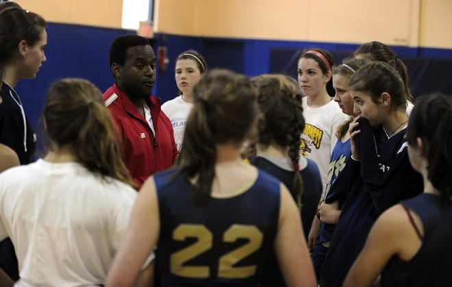 Mass Wildcats Under-12 girls AAU coach Patrick Ferdinand talks to his team during last night's practice at the Cambridge School of Weston.