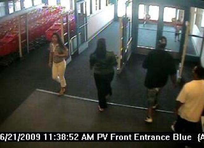 A short time after this surveillance photo was taken, the woman at far left was seen in a dark colored four-door vehicle involved in a June 21 attempted armed robbery.