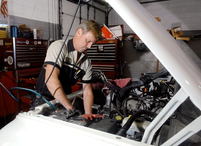 Tom Winterbower tears down an engine on a 2002 Dodge Durango in the service area at the Estes Dodge City Hyundai Mahindra dealership on Vandiver Drive. Winterbower has worked as an automotive technician at the dealership for 20 years.