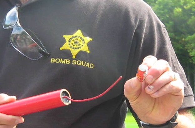 Sgt. Mark Jenis, of the Monroe County Sheriff's Department compares a commercial firework to one made and sold illegally.
