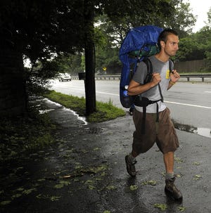 7/2/09-- Daily News photo by Art Illman 
Josh Stieber walks along Route 9 west yesterday in Wellesley, part of his cross-country hike. Stieber, of Maryland, is stopping to talk about his opposition to the Iraq War, which he participated in as an infantrymen for 14 months.