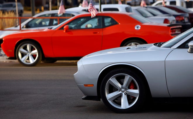 FILE - In this March 1, 2009 file photo, 2009 Dodge Challengers sit at a Dodge dealership in the south Denver suburb of Littleton, Colo. Only one Chrysler Group LLC model showed a sales increase over June of last year, the Dodge Challenger muscle car.(AP Photo/David Zalubowski, File)
