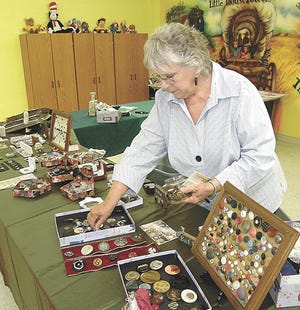 Lorraine Shuey sets up her button collection at the Lilian S. Besore Memorial Library in Greencastle.