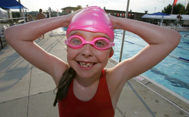 Addie Levandowski, 7, takes a break from swimming during practice at the Marion County YMCA in Ocala on June 25.