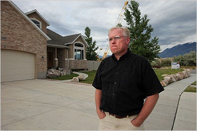 Paul Furse in front of the home that he and his family built, now lost to foreclosure.
