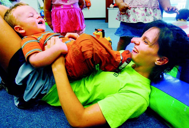 Matthew Miller, 20 months, plays with employee Lauren Logsdon at Teddy Bear Christian Child Development Center in Riverton. Matthew is one of Teddy Bear’s clients who is subsidized through the Illinois Department of Human Services, which is in danger of having funds cut.