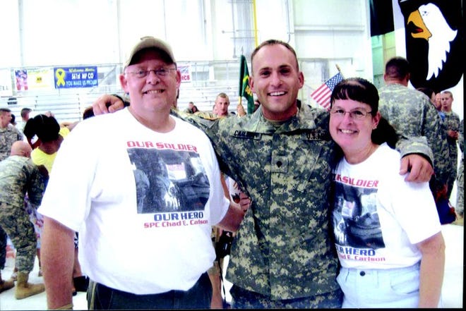 Chad Carlson with his parents, Todd and Cheri Singleton, at Fort Campbell on June 29. Carlson arrived home from Iraq that day and is expected to be in Monmouth Saturday.