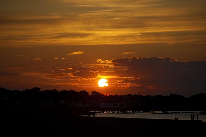 The sun sets over Boston in this view from Wollaston Beach. See more photos by Liz Feitelberg on the South Shore Camera Club blog, http://ssccphotoblog.wordpress.com.