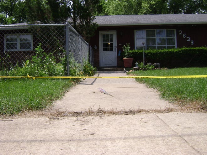 A single rose lies on the sidewalk outside a Rockford couple’s home Thursday, July 9, 2009. The couple were found dead Wednesday inside their home.