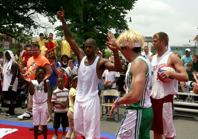 Springfield High graduate Brian Price, center, celebrates after the announcement that he had won the 2009 Gus Macker Slam Dunk Contest in downtown Springfield, Ill., July 11, 2009. Justin L. Fowler/The State Journal-Register
