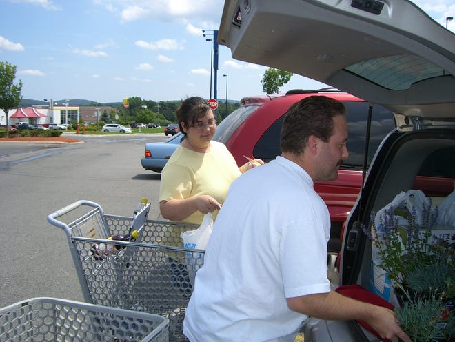 Heather and Sean Palmer from Rutland put purchases into their car at Wal-Mart in Westborough.