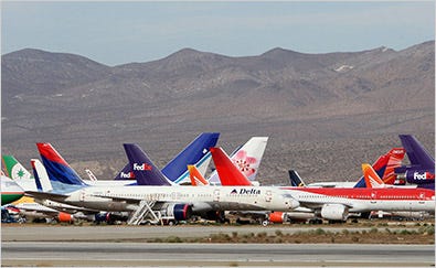 To weather the downturn, airlines have grounded planes. Above, idle planes at an airport in Victorville, Calif.
