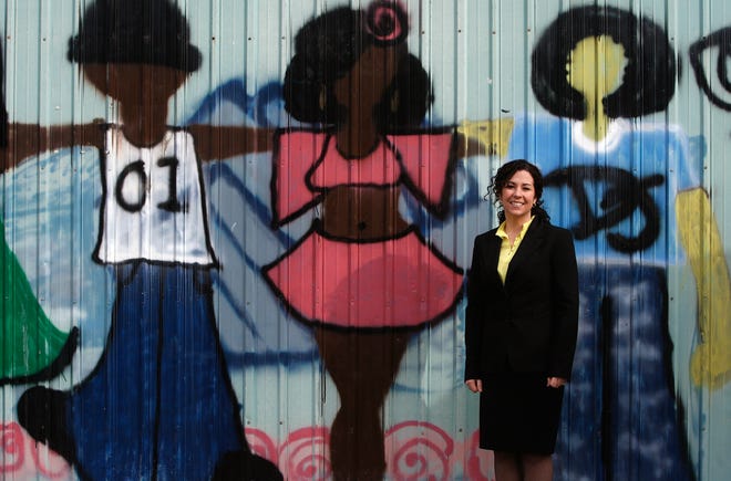 Executive director Jill Young Shurtz poses with artwork at the Central Unit of the Boys & Girls Club of Central Illinois, 300 S. 15th St.
 David Spencer/The State Journal Register