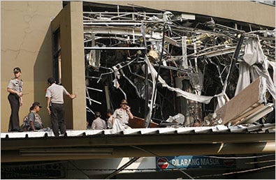 Police officers inspected the damage after an explosion went off at the Marriott hotel in Jakarta on Friday.