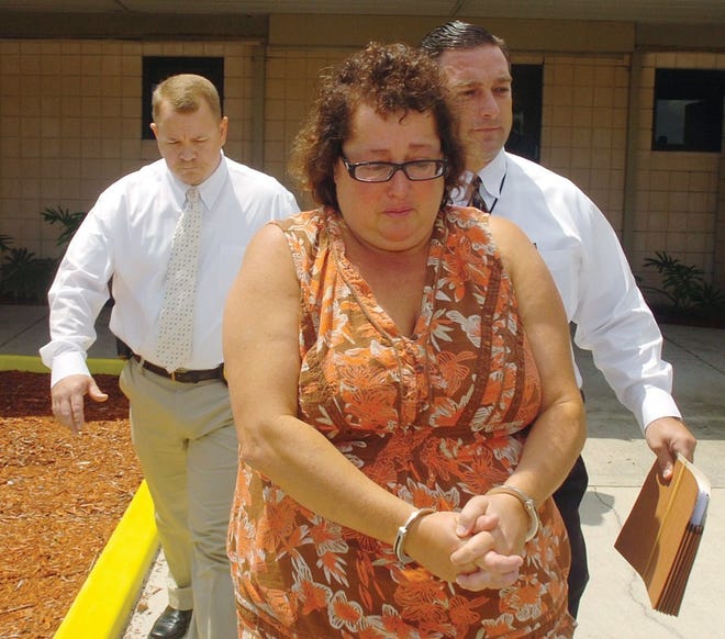 PETER WILLOTT/St. Augustine RecordState Attorney investigators take Northwest resident Diane Santarelli from the St. Johns County Sheriff's office after her arrest on manslaughter charges July 10.