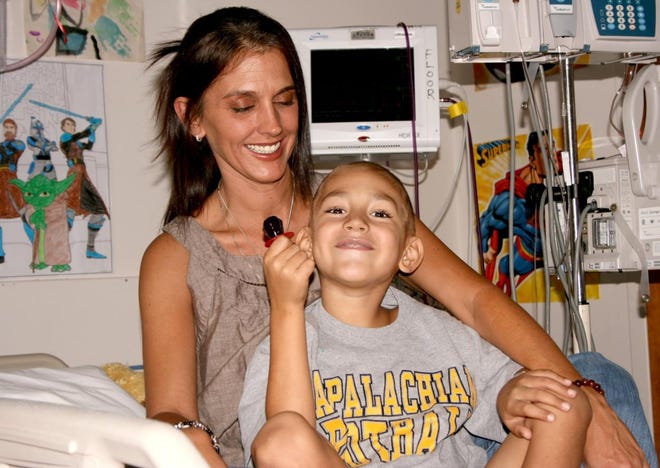Karin Langdon and her 6-year-old son, Brayden, share a laugh from his room in the pediatric unit at Memorial University Medical Center in Savannah. Last month, Brayden was diagnosed with a rare and aggressive type of leukemia. He is undergoing intensive chemotherapy to prepare for a bone marrow transplant operation, but a suitable donor has not been found. (Mike Perry/Effingham Now)