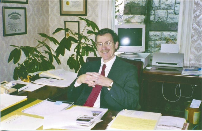 Attorney John Kennedy sits in his office in Canandaigua, where he practiced law and ran the Ontario County assigned counsel program.
