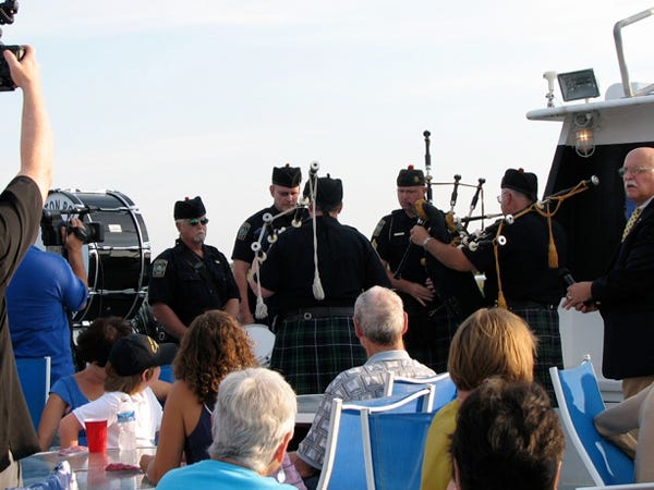 The Wilmington Police Pipe and Drum corps plays “Danny Boy” aboard the Royal Winner Princess on Sunday. Friends and family gathered to scatter the ashes of the late actor Pat Hingle in the sound near his home in Carolina Beach.