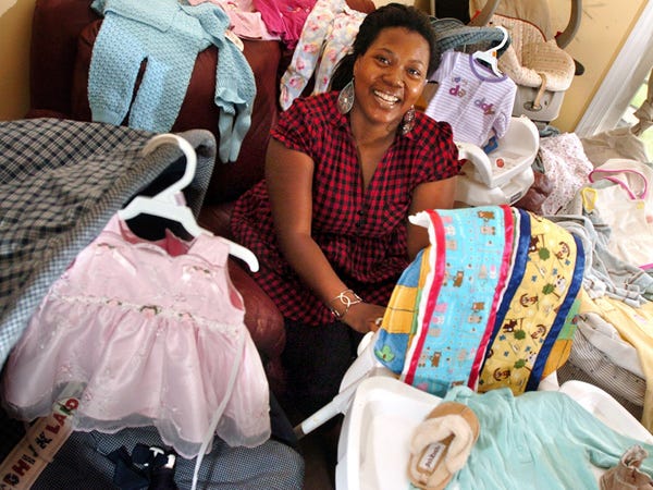 Khalilah Olokunola is surrounded by baby items for her Daughters of the King ministry Monday, July 6, 2009.
