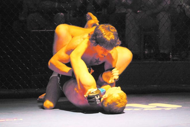 Danny Connerly tries to avoid a triangle choke during the first round of Saturday's MMA fight at the Rivoli.