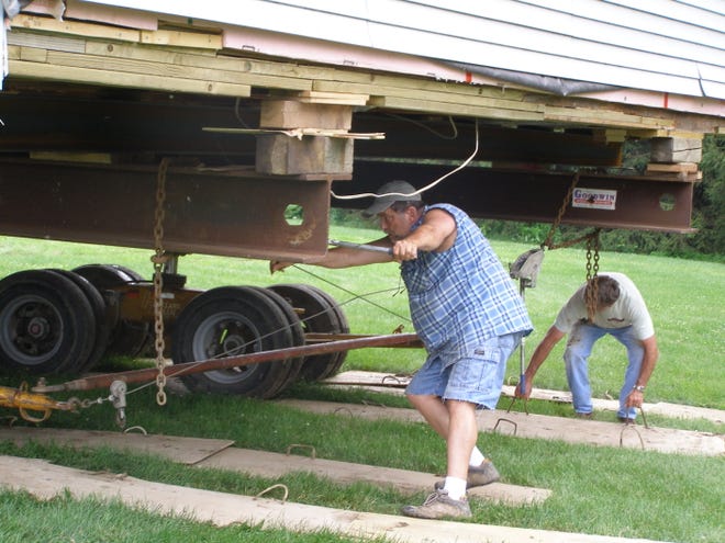 Bob and Chris Wells of rural Cambridge decided to have their house in rural Cambridge moved down a lane and about a mile west of its former location. They hired the Goodwin House Moving Company of Washington, Iowa, to perform the task.