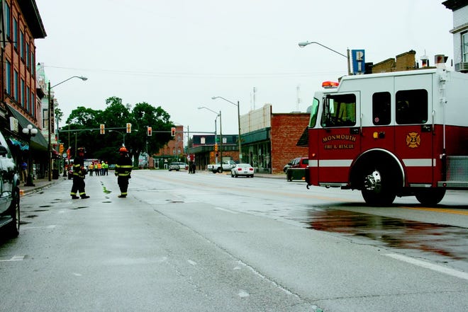 Members of the Monmouth Fire Department block off the 100 block of South Main Street late Tuesday morning until a broken gas line was fixed. The line was inadvertently broken while the Water Department was working on a water line at the corner of South Main Street and West First Avenue.