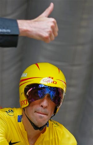 A race official counts down as Alberto Contador of Spain, wearing the overall leader's yellow jersey, takes the start of the 18th stage of the Tour de France cycling race, an individual time-trial of 40.5 kilometers (25.2 miles). Contador won the stage ahead of Fabian Cancellara of Switzerland.