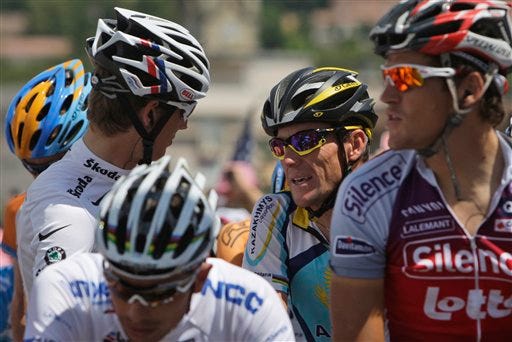 American seven-time Tour de France winner Lance Armstrong, right, talks to Andy Schleck of Luxembourg, wearing the best young rider's white jersey, left, prior to the start of the 19th stage of the Tour de France cycling race over 178 kilometers (110.6 miles) with start in Bourgoin-Jallieu and finish in Aubenas, southern France, Friday July 24, 2009.
