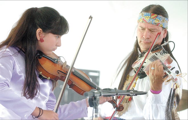 Victor resident Angel Jimerson, a Seneca, plays a duet with Arvel Bird, a Paiute, of Arizona, during the Native American Dance & Music Festival on Saturday. It’s the 18th year for the two-day festival, held at the Ganondagan State Historic Site.