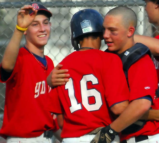 Sudbury's Jake Earle (16) is congratulated by teammates Matt McGavick (left) and Ricky Antonellis after scoring what proved to be the winning run in Sudbury's 6-4 win over Framingham.