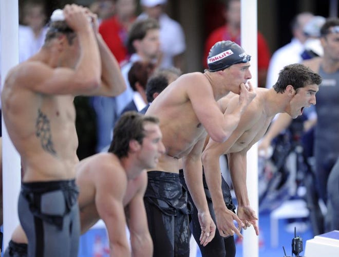 Michael Phelps , right, and Ryan Lochte of the United States react during the final of the Men's 4x100M relay, at the FINA Swimming World Championships in Rome, Sunday, July 26, 2009. The United States won the gold.