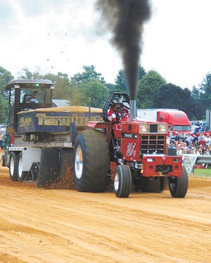 A tractor lets off some steam Saturday night at the new truck and tractor pull track at the Mont Alto Volunteer Fire Department fairgrounds.