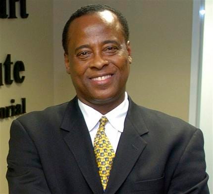 In this July 7, 2006 file photo, Dr. Conrad Murray poses for a photo as he opens the Acres Homes Cardiovascular Center at the Tidwell Professional Building, in Houston.