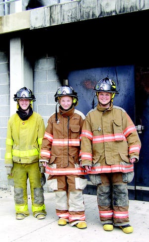 Brandon Shinn, Alexandra Gladhill and Makaylyn Leister get adult experiences in a controlled setting during the Junior Fire Academy for Franklin County teens.