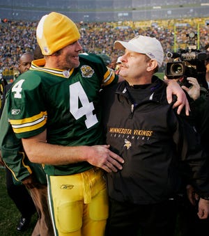 FILE - In this Nov. 11, 2007, file photo Green Bay Packers quarterback Brett Favre (4) talks to Minnesota Vikings coach Brad Childress after an NFL football game in Green Bay, Wis. Childress said Tuesday, July 28, 2009, that Favre won't play for the Vikings.