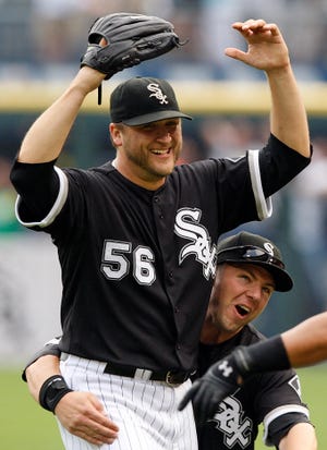 Chicago White Sox pitcher Mark Buehrle is embraced by teammate Josh Fields after tossing a perfect game against the Tampa Bay Rays on Thursday, July 23, 2009, in Chicago. The White Sox won 5-0.
(AP Photo/Jim Prisching)