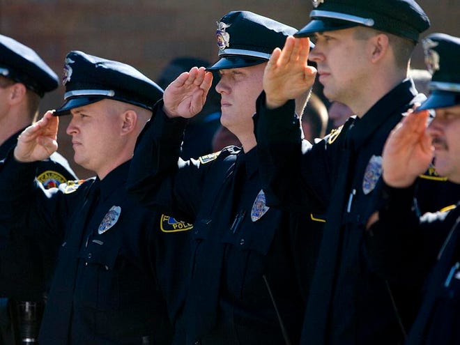 Tuscaloosa Police officers salute during the Pledge of Allegiance at a swearing-in ceremony for the police chief, Steve Anderson, at the Tuscaloosa Police Department in Tuscaloosa, Oct. 1, 2008.