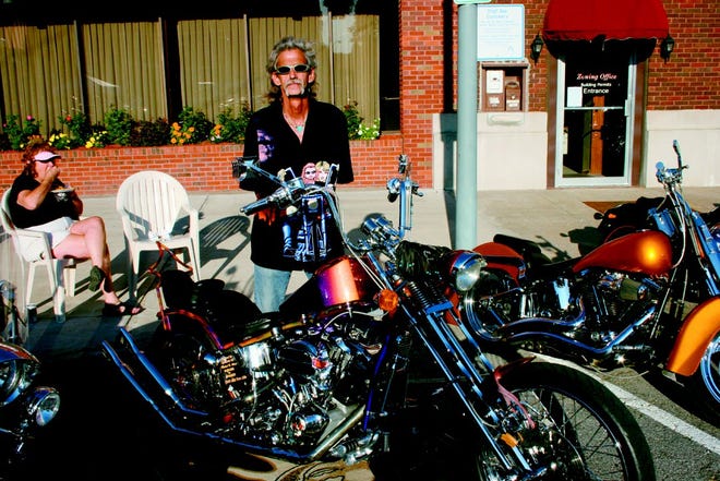 Dave Adams (a.k.a Felix) stands with his 1976 custom built Shovel motorcycle at the Monmouth Car Show on Friday evening. It took Adams about three years to build the bike.