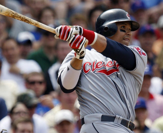 This is a June 19, 2009 file photo showing Cleveland Indians' Victor Martinez hitting a three-run home run against the Chicago Cubs during the third inning of a baseball game in Chicago. The Boston Red Sox got the big bat they were looking for, acquiring All-Star slugger Victor Martinez from the Cleveland Indians on Friday, July 31, 2009.