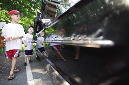 Liam McQuillen, 7, left, of Portsmouth, and his brother, Brendan, 4, right, look at a 1964 Thunderbird convertable during the vintage Thunderbird show at the Mark Wentworth Home on Pleasant Street in Portsmouth on Saturday, Aug. 1, 2009. The car's owners, Roland and Rachel Labrecque of Merrimack, NH, say they have owned the vehicle for 12 years and they are the third family to own the car.