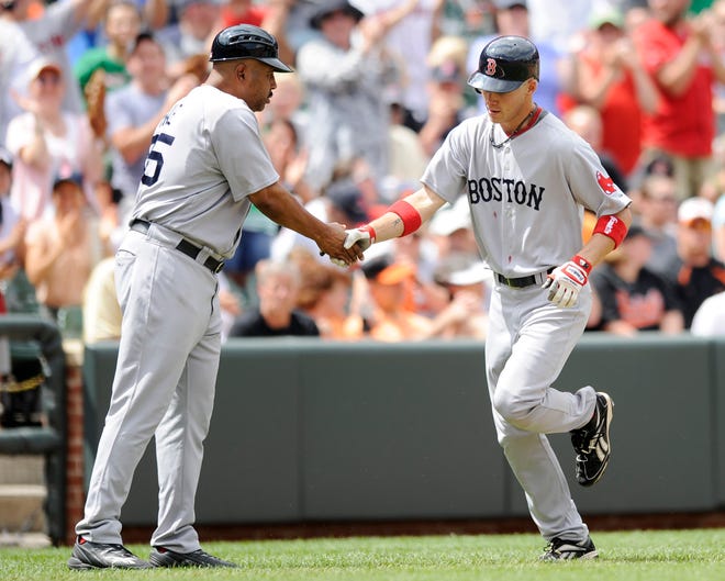 Red Sox rookie Josh Reddick (right) is greeted by third base coach DeMarlo Hale after hitting a home run in the third inning of yesterday's game against the Orioles in Baltimore. It was his first major league homer