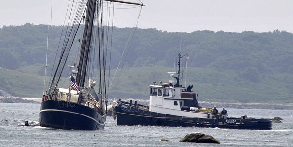 The New Jersey-based tall ship Unicorn, carrying an all-female crew and teen girls learning to sail, ran aground in a Woods Hole passage known for giving vessels trouble. Here, a tug gives assistance.