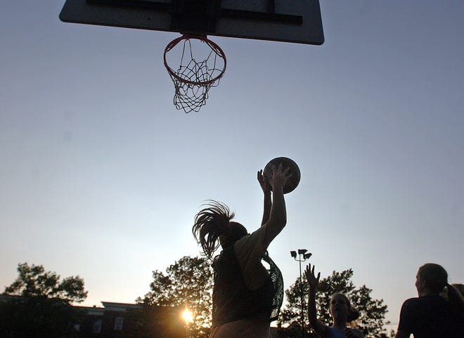 Basketball players keep a game going as the sun sets at Merrymount Park on a warm summer evening. 

photo: Amelia Kunhardt