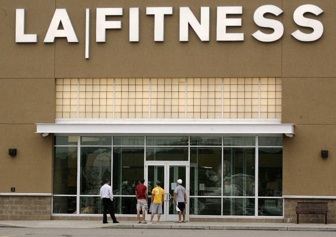 Members show up to workout early yesterday at the LA Fitness in Bridgeville, Pa., where a guman killed three woman the day before.